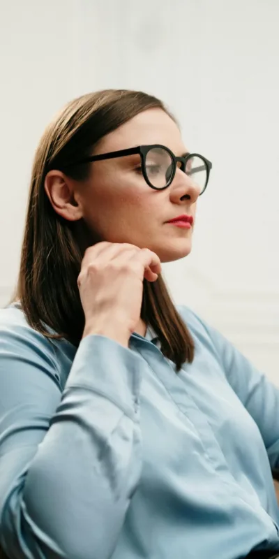 Woman in Blue Long Sleeve Shirt Wearing Black Framed Eyeglasses
